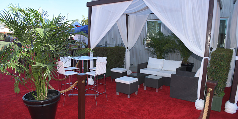 VIP Tailgate Cabana with open sides and furnitre and carpet area